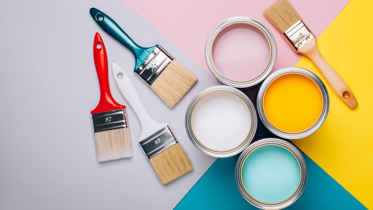 Four,Open,Cans,Of,Paint,With,Brushes,On,Bright,Background.